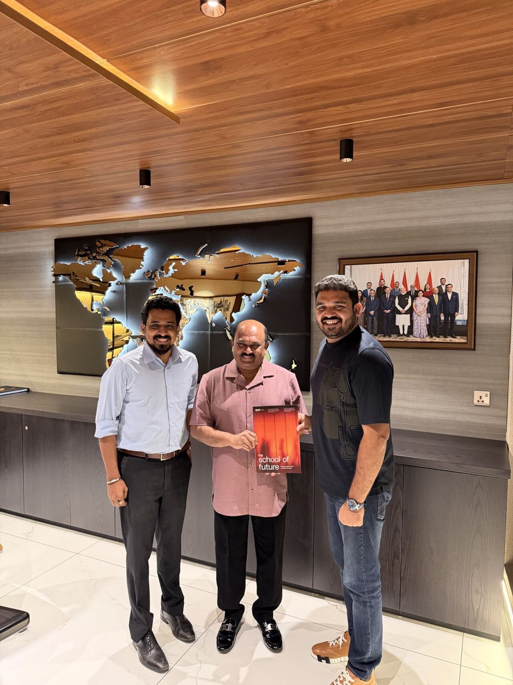 Akshay and a colleague presenting the SOF prospectus to a business leader in his office